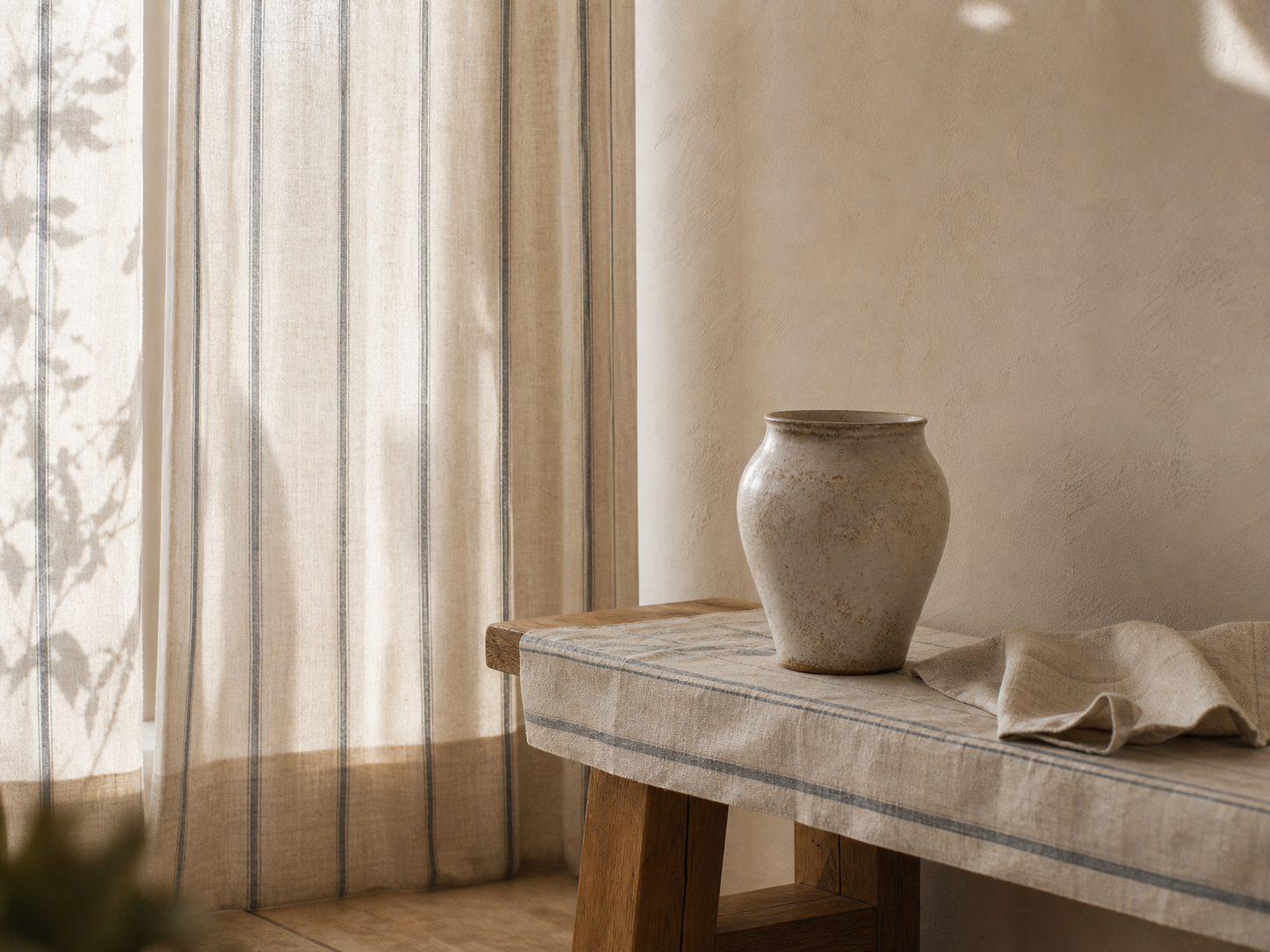 Soft striped linen curtains and a striped runner in warm natural light