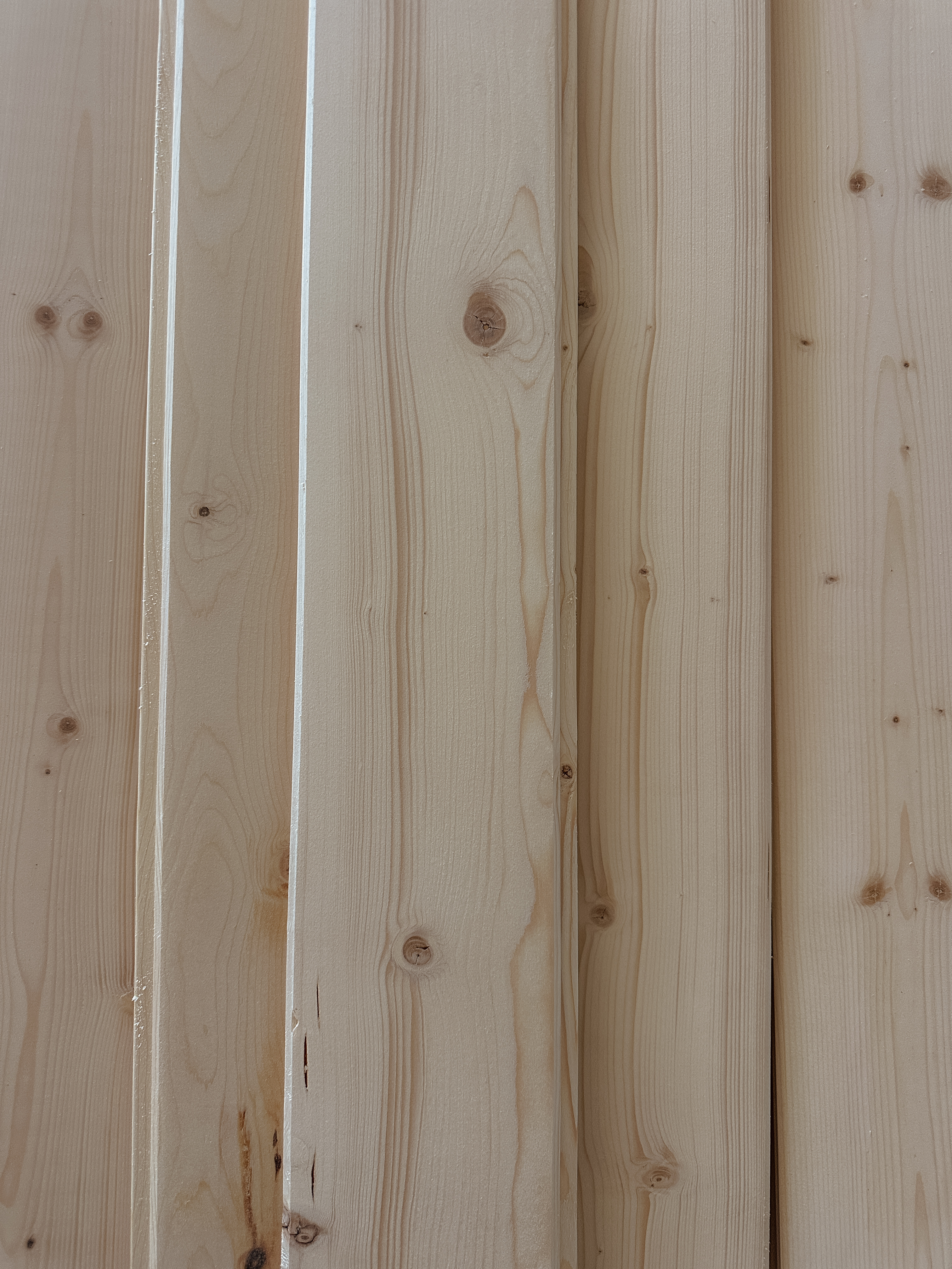 Fresh pale pine boards ready for a custom home build
